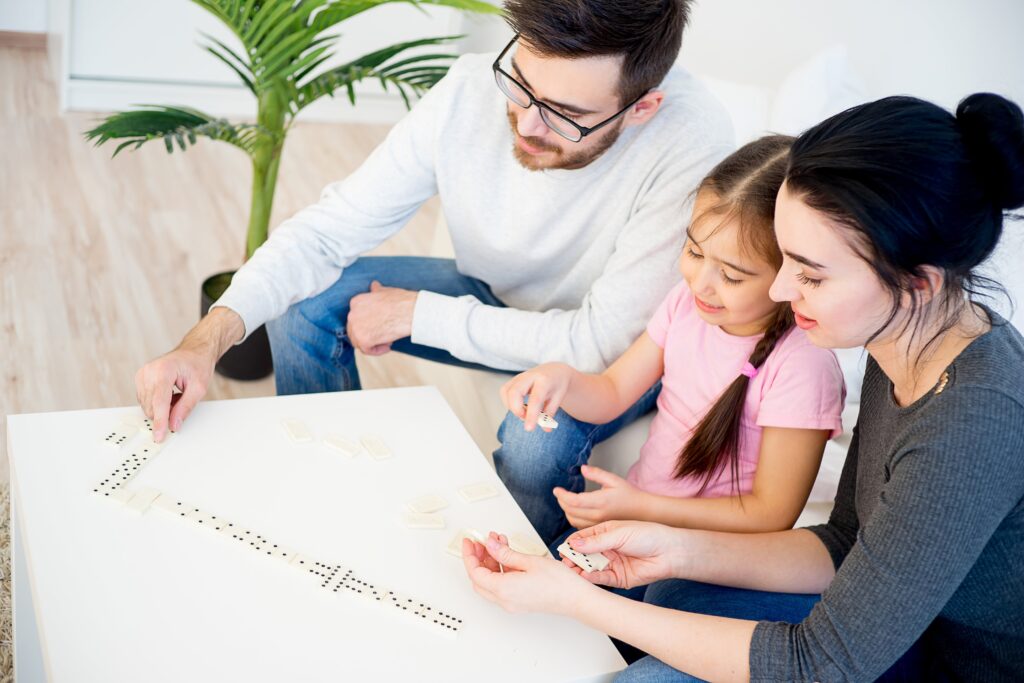 happy family playing board games together at home